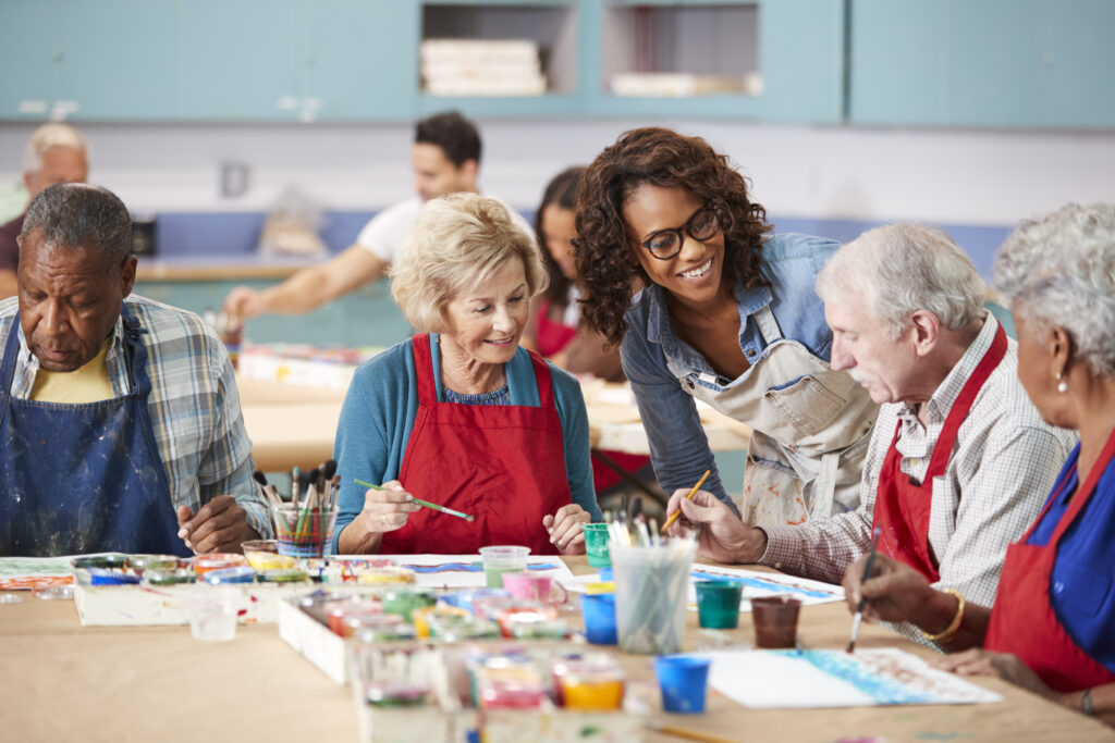 Art Therapy for Seniors: Group Of Retired Seniors Attending Art Class In Community Centre With Teacher